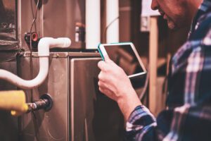 A technician inspecting a heat pump system